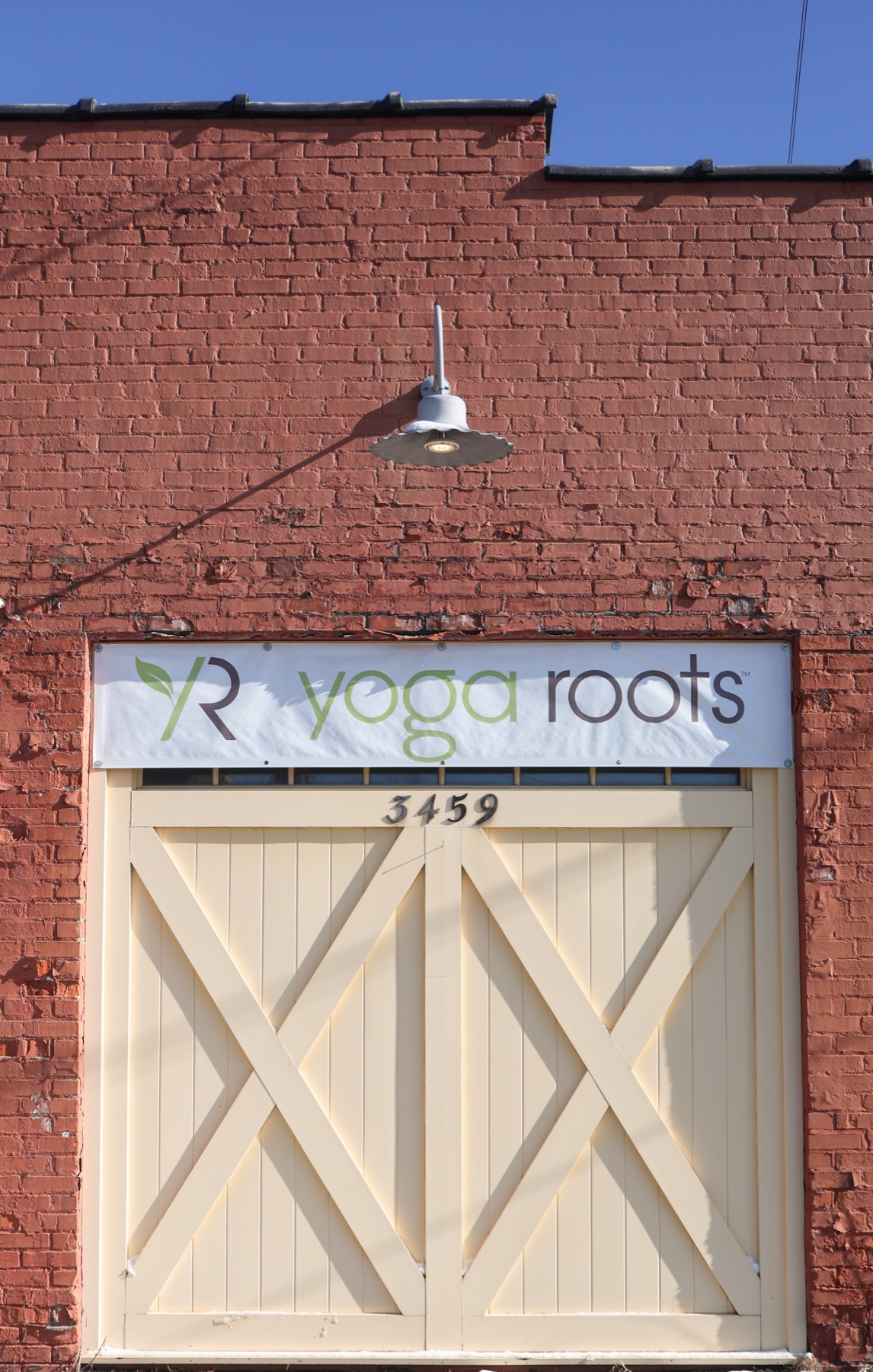 Yoga Roots barn doors and sign at 3459 Fairmount